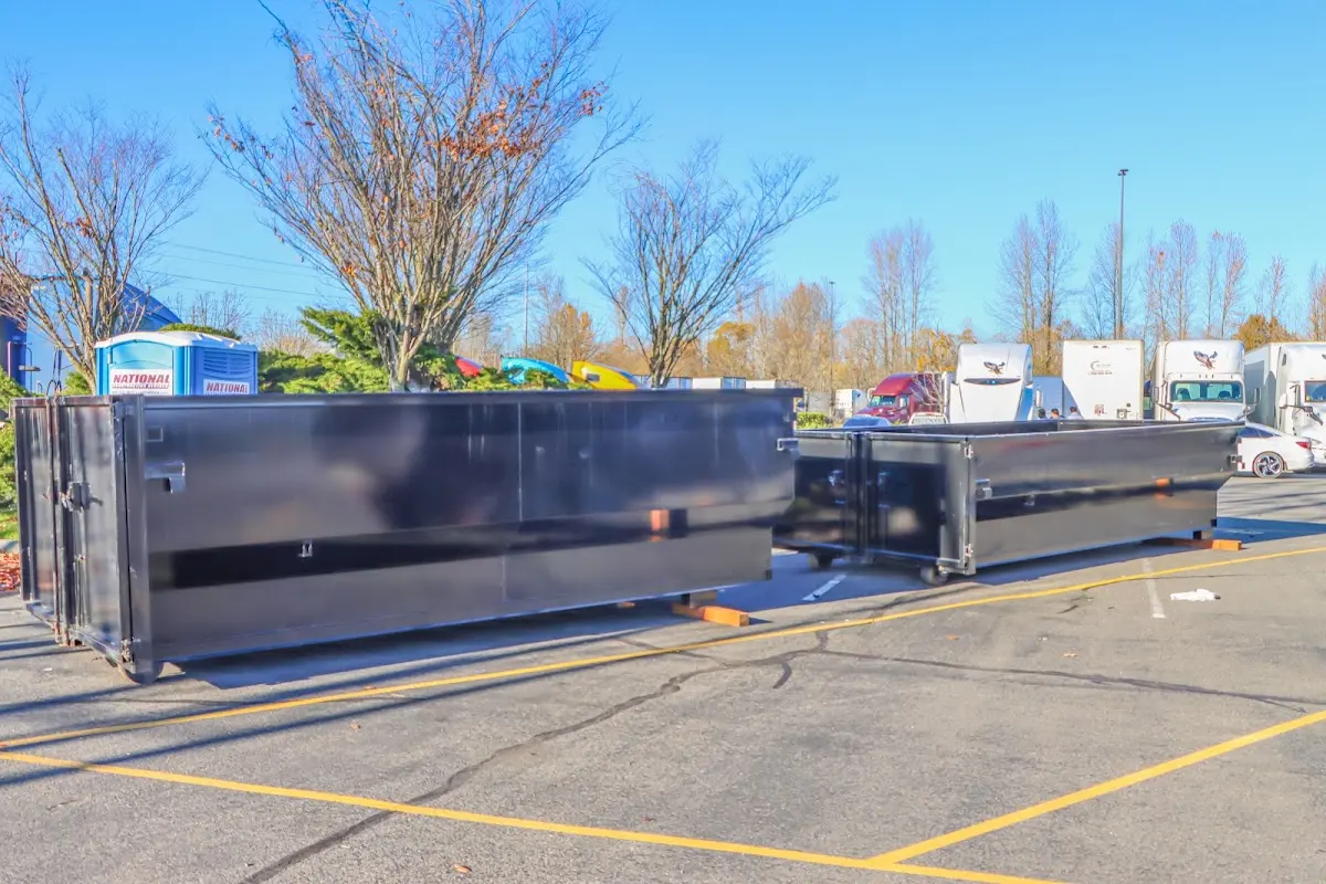 Professional dumpster rental service with roll-off container on residential driveway in Bothell